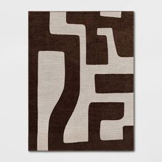 a brown and white rug with an abstract design