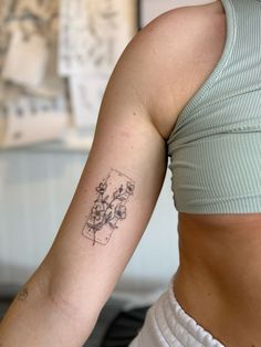 a woman with a flower tattoo on her left arm and right arm behind her back