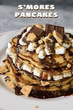 a stack of pancakes topped with marshmallows and chocolate