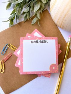 a notepad with the words donut comfort on it next to some office supplies