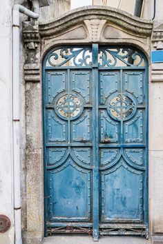 an old blue door with ornate iron work