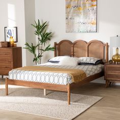 a bed sitting on top of a wooden floor next to a dresser