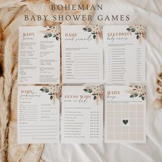 four baby shower games laid out on a bed