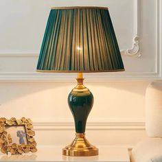 a green lamp sitting on top of a table