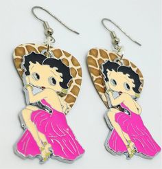 the earrings are shaped like a giraffe with a woman in a pink dress