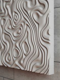 a close up of a tile wall with wavy designs on the outside and inside of it