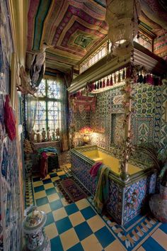 an elaborately decorated bed in the middle of a room with large windows and checkered flooring