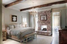 a bedroom with a brick fireplace and bed