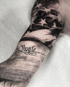 a man's arm with an american flag and the word people written on it