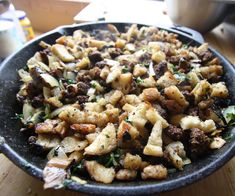 a pan filled with food sitting on top of a wooden table