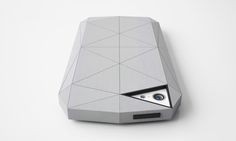 an electronic device that is shaped like a triangular object with a hole in the middle