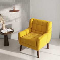 a yellow chair sitting next to a table with a book on it and a lamp