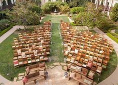 rows of wooden chairs sitting on top of a lush green field