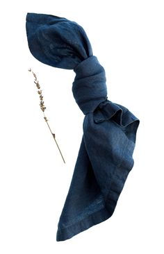 an image of a blue scarf tied to a headband with a single flower on it