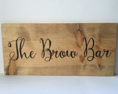 a wooden sign that says the brown bar on it's side, with leaves