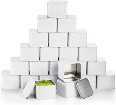 several white square boxes stacked on top of each other with a candle in the middle