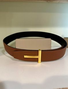 Grain Leather T Icon Black & Tan Reversible Belt with Gold Buckle . Comes with box, and dust bag. Belt width is 40mm which is 1.5 inches Belt With Gold Buckle, Nice Belts, Bag Belt, Reversible Belt, Suspender Belt, Wide Straps, Black Tan, Suspenders, Black And Tan