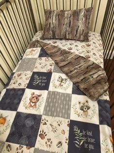 a baby crib with a blanket and pillow on it