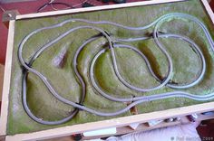 an open box with multiple wires in it on top of a green carpeted floor