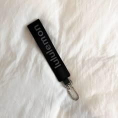 a black lanyard keychain with the word innovation on it sitting on a white sheet