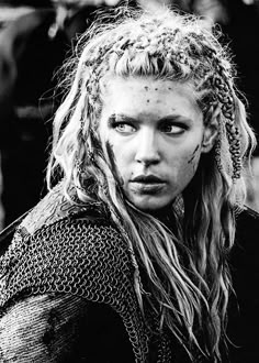 black and white photograph of a woman with dreadlocks on her head, looking at the camera