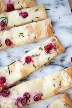 cranberry and rosemary bread sticks on a marble counter