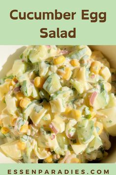 a bowl filled with corn salad on top of a green tablecloth and the words cucumber egg salad above it