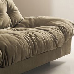 a brown couch sitting on top of a white floor