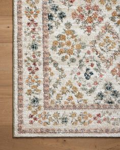 an area rug with various colored flowers on it