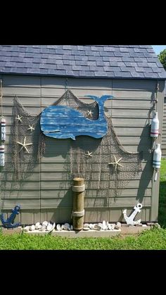 a blue shed with sea creatures on the side