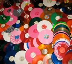 there are many different colored discs on the floor