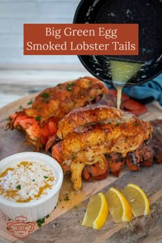 the big green egg smoked lobster tails are being drizzled with lemon juice