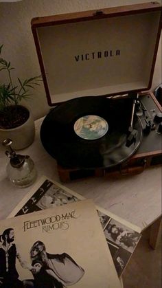 an old record player sitting on top of a table