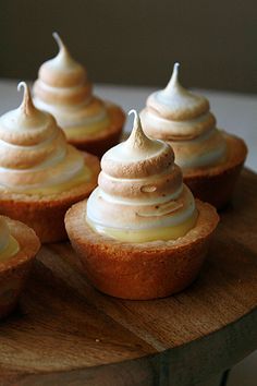 cupcakes with frosting on top sitting on a table