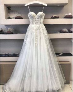 a white wedding dress on display in a store