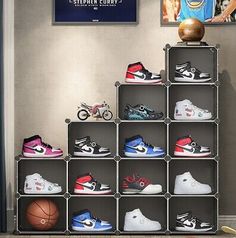 there are many pairs of shoes on display in this room with basketballs and other sports memorabilia