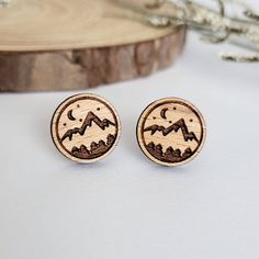 These beautiful wooden mountain scenery stud earrings are meant for every nature lover, hiker, and adventurer alike. Best of all, they are also hypoallergenic, lightweight, and great for everyday wear! Each pair of earrings is laser cut in-house using sustainable American hardwood and sealed with a hypoallergenic shellac topcoat. Earrings are finished with hypoallergenic stainless steel posts. Material: sustainable American hardwood Sizing: 0.5 inch L x 0.5 inch W Mountain And Forest, Mountain Earrings, Wood Earrings Stud, Bee Studs, Mountain Lover, Mountain Scenery, Bee Earrings, Gifts For Nature Lovers, Wood Earrings