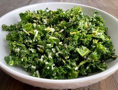 a white bowl filled with broccoli on top of a table