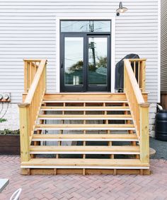 a wooden staircase leading up to a front door