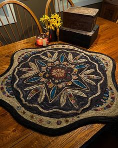 a wooden table topped with a round rug