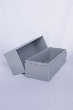 two gray boxes sitting side by side on a white surface