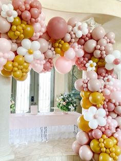 the balloon arch is decorated with pink, white and gold balloons in an elegant setting