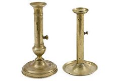 two antique brass candlesticks on white background