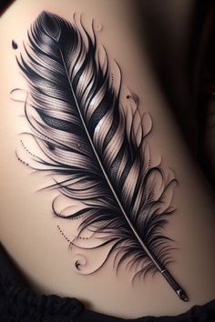 a woman's stomach with a black and white feather tattoo on the side of her belly