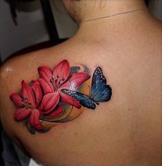 a woman's back with red flowers and butterflies on her left shoulder, while the rest of her upper half is visible