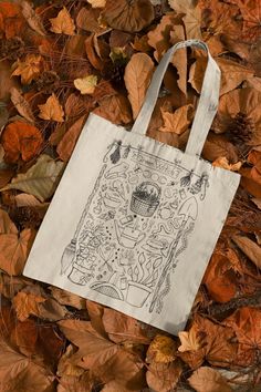 a tote bag sitting on top of leaves