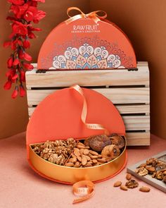 an orange heart shaped box filled with nuts