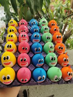 there are many different colored balls with eyes on them in the shape of monster heads