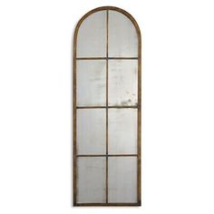 an arched window with glass and wood frame