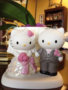 a hello kitty wedding cake topper on a table